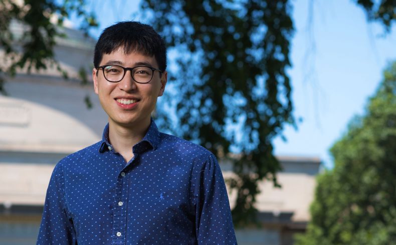 Robert Yang standing in front of the MIT Dome