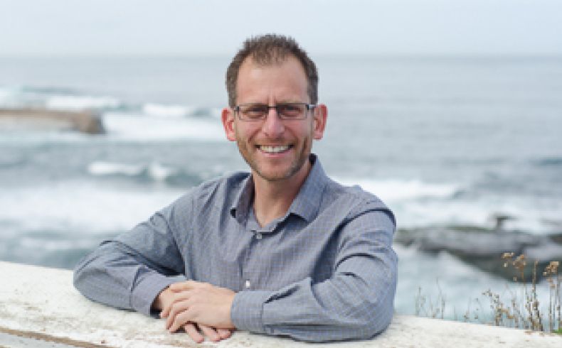Prof Levy standing with ocean behind him