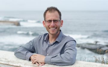 Prof Levy standing with ocean behind him