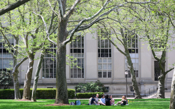Image of students sitting on the grass around MIT's campus