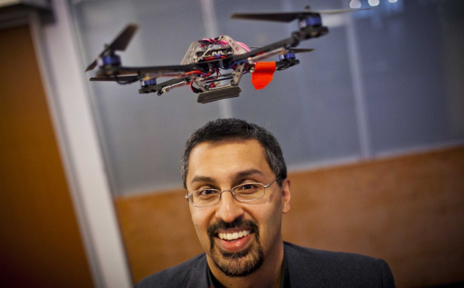 Nick Roy with a drone flying overhead