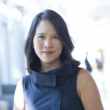 Lily Tsai in a blue shirt on a blurred background 